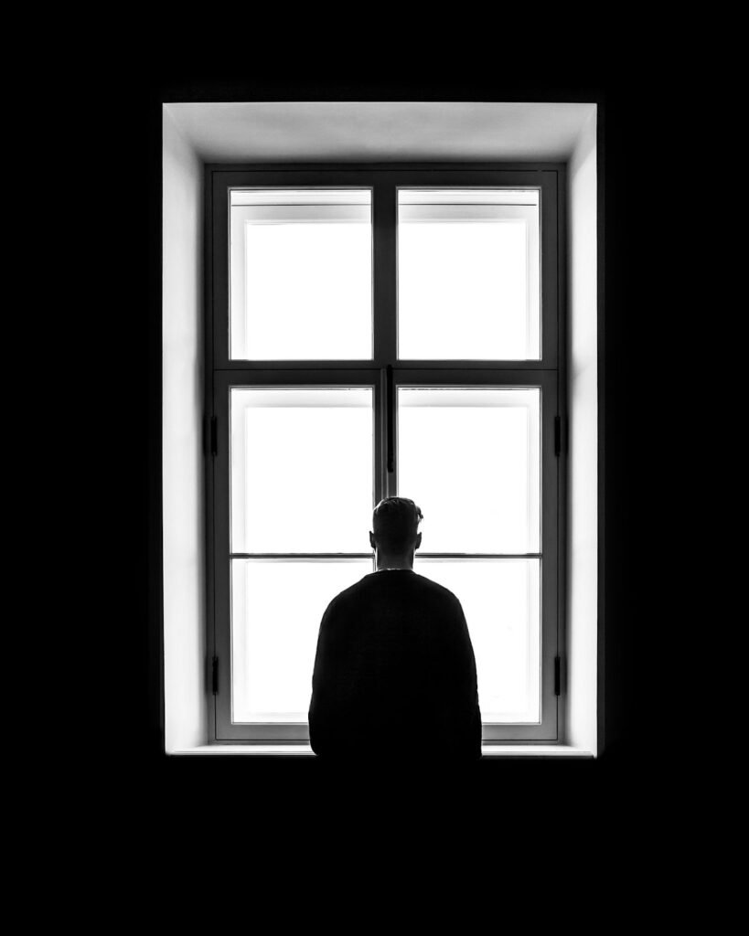 Placeholder founder portrait, a seated figure at a window, to be replaced with a photograph of Lawrence